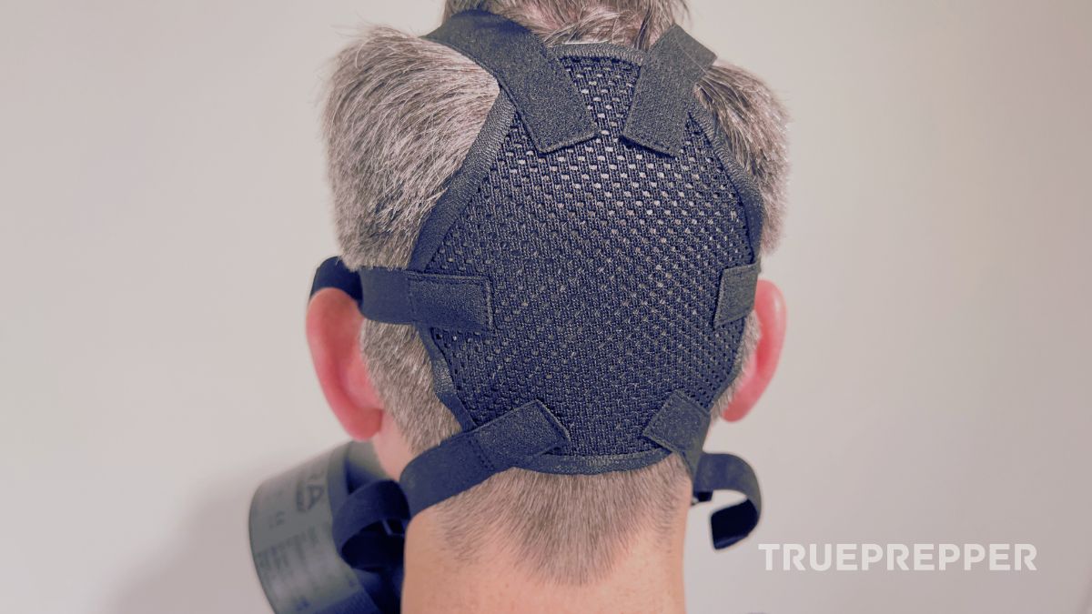 Back of Sean's head showing the Mira CM-6M head harness webbing and straps.