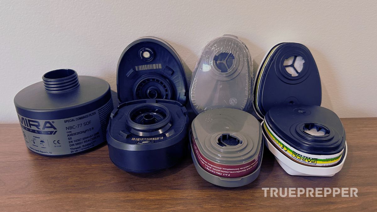 Different types of gas mask filters on a table.