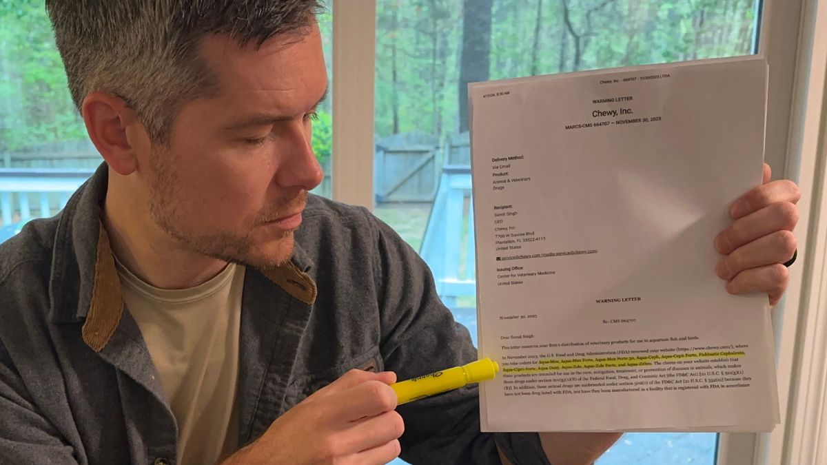 Sean holding up the FDA warning letter to Chewy with the fish antibiotics highlighted.