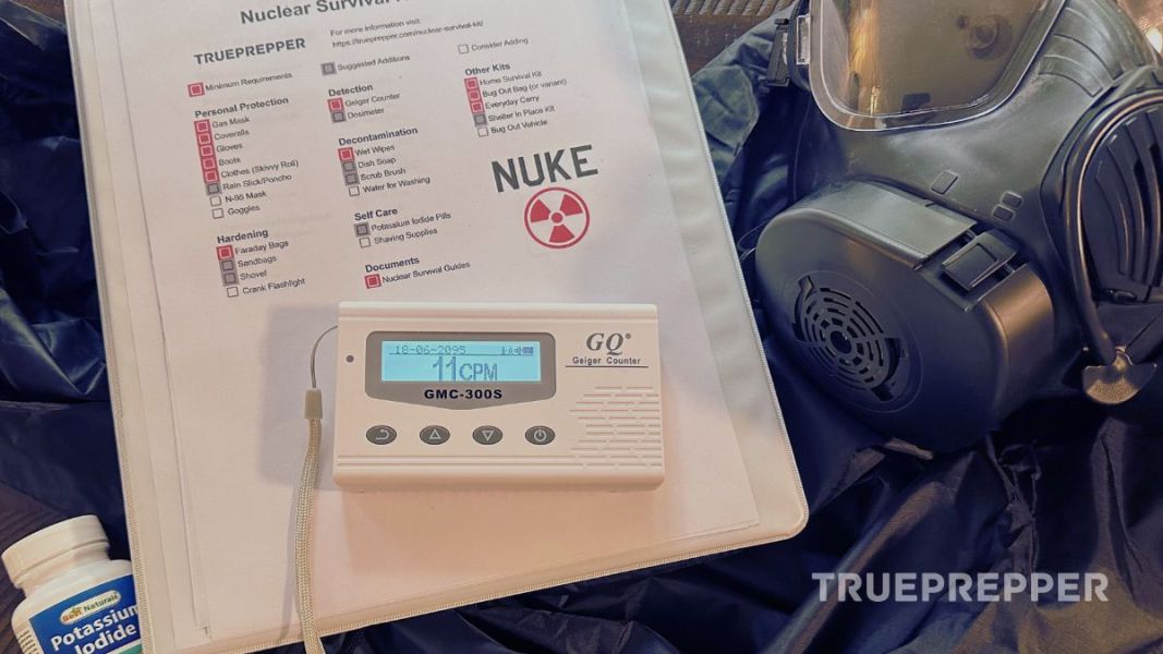 A GMC-300S Geiger Counter showing 11CPM background laying on top of a nuclear survival binder.